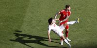 epa10327013 Joe Rodon (R) of Wales in action against Sardar Azmoun of Iran during the FIFA World Cup 2022 group B soccer match between Wales and Iran at Ahmad bin Ali Stadium in Doha, Qatar, 25 November 2022.  EPA-EFE/Rungroj Yongrit