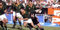 24 Aug 1996:  Joost Van Der Weisthuizen of South Africa is tackled by Josh Kronfeld in the second Test in Pretoria. Mandatory Credit: Dave Rogers/Allsport