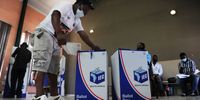 A voter wearing an IFP T-shirt casts his vote at the voting station in Johannesburg City Hall. (Photo: Leon Sadiki)