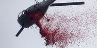 An Indian Army helicopter drops rose petals during a Republic Day parade at the Red Road in the eastern Indian city of in  Kolkata, India, 26 January 2023. The 'Republic Day of India' marks the date on which the Constitution of India came into force on 26 January 1950 and the country began its transition from a British Dominion into a republic. The  celebrations of Republic Day usually include various parades including shows of military equipment and cultural displays.  EPA-EFE/PIYAL ADHIKARY