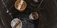 Residents of Sagbo Kodji throw their fetching buckets into open, and free, wells in a rush for clean water before it disappears. (Photo: Nengi Nelson)