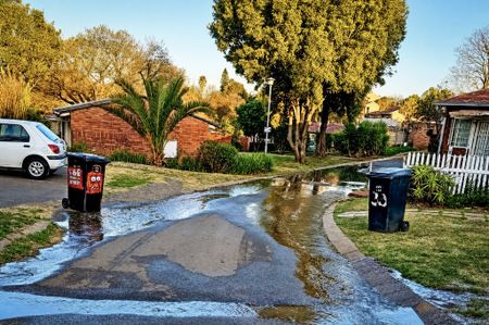 Community members clean up sewage spill at old age home after City inaction