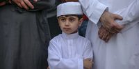 epa09922097 A Palestinian child joins adults in Eid al-Fitr prayers in Gaza City, 02 May 2022. Muslims around the world celebrate Eid al-Fitr, the three days festival marking the end of Ramadan. Eid al-Fitr is one of the two major holidays in the Islamic calendar.  EPA-EFE/MOHAMMED SABER
