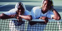 Venus (left) and Serena Williams take time off from a practice session to pose together during the Adidas International event at White City in Sydney, Australia. 16 January 1998. (Photo:   Clive Brunskill)