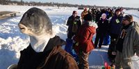 BRAINERD, MINNESOTA - JANUARY 29: Fishermen wait for a shuttle on the ice at Gull Lake following the Brainerd Jaycees Ice Fishing Extravaganza on January 29, 2022 in Brainerd, Minnesota. About 10,000 anglers were expected to compete in the tournament, which is billed as the "largest charitable ice fishing contest in the world".  (Photo by Scott Olson/Getty Images)