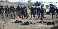 SAPS officers advance after shooting striking workers with live ammunition in Marikana, North West province, South Africa on 16 August 2012. “The Marikana massacre was a turning point for Oupa Lehuleler,” writes the author. (Photo by Gallo Images / Foto24 / Felix Dlangamandla)