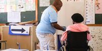 An IEC staff member assists an elderly voter in Bloemfontein, Free State on 1 November 2021 during the local government elections. (Photo: Lihlumelo Toyana)