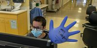 SEATTLE, WA - NOVEMBER 26: Jordyn Oleachea, a nurse, works near an inflated glove with a Thanksgiving message on it in the trauma surgery ICU at Harborview Medical Center on November 26, 2020 in Seattle, Washington. Healthcare workers on the frontline of the Covid-19 pandemic continued their work on the Thanksgiving holiday. (Photo by David Ryder/Getty Images)
