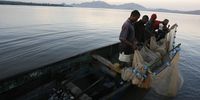 A family of fishermen check their nets in the early morning hours on Lake Victoria near Homa Bay. (Photo: EPA/Stephen Morrison)