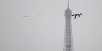 PARIS, FRANCE - JULY 26: Tightrope walker Nathan Paulin performs on a high rope during the athletes parade on the River Seine near the Supreme Court during the opening ceremony of the Olympic Games Paris 2024 on July 26, 2024 in Paris, France. (Photo by Buda Mendes/Getty Images)