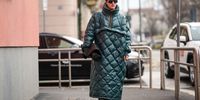  A guest wears sunglasses, a green padded quilted long oversized coat, a black leather bag, leather shoes, outside K-WAY, during the Milan Fashion Week - Menswear Fall/Winter 2024-2025 on January 14, 2024 in Milan, Italy. (Photo by Edward Berthelot/Getty Images)