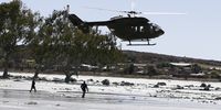 A military helicopter flies over search and rescue teams in Charlesville, Jagersfontein after the tailings dam collapse. (Photo: Felix Dlangamandla)