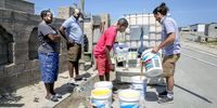 Steph Venter from Food Maniacs (far right), distributes soup to residents of Samora Machel township in Cape Town. (Photo: Zeke du Plessis)