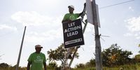 Hammanskraal resident Solomon Ngwepe erects Action SA posters on a street pole located on the side of Harry Gwala avenue on 16 May 2024.(Photo: Felix Dlangamandla)