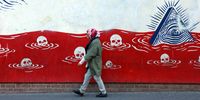 epa11705020 An Iranian woman walks past an anti-US mural near the former US embassy in Tehran, Iran, 06 November 2024. The Republican candidate for president Donald J. Trump, has been elected as the 47th President of the United States after obtaining over 270 of the Electoral College votes, succeeding against Democratic candidate and current Vice President Kamala Harris.  EPA-EFE/ABEDIN TAHERKENAREH