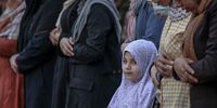 epa09922117 A Palestinian child joins adults in Eid al-Fitr prayers in Gaza City, 02 May 2022. Muslims around the world celebrate Eid al-Fitr, the three days festival marking the end of Ramadan. Eid al-Fitr is one of the two major holidays in the Islamic calendar.  EPA-EFE/MOHAMMED SABER