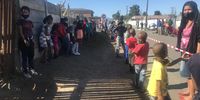 Dozens of children wait in snaking lines for a warm meal from a soup kitchen run by community activist Latifa Jacobs from her home in Kuilsriver. She says they feed thousands of people. (Photo: Tariro Washinyira)