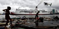 Villagers collect belongings following a storm surge brought by an approaching typhoon that destroyed their homes, at a coastal village in Manila, Philippines, 02 October 2023. The Philippine government weather bureau warned residents in northern Luzon island of possible flash floods and landslides that may be triggered by heavy rains brought by tropical cyclone Koinu, which recently reached typhoon category. Koinu is located 675 kilometers east of Aparri, Cagayan province packing maximum sustained winds of 120 kilometers per hour (kph) near the center and gustiness of up to 150 kph.  EPA-EFE/FRANCIS R. MALASIG