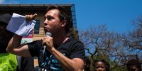 Alex Lenferna, secretary of the Climate Justice Coalition, addresses the crowd. (Photo: Julia Evans)