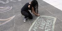 An artist at the Artscape Plaza in Cape Town takes part in at a protest on on 27 March 2021 over funding irregularities. (Photo: Gallo Images / Brenton Geach)