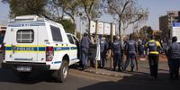 Police waiting on the road outside a park where Police Minister Bheki Cele is addressing Jeppestown residents on 3 September 2019 following days of violence. Photo: Aisha Abdool Karim