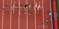 TOKYO, JAPAN - AUGUST 07: A general view of the baton exchange between Dalilah Muhammad and Athing Mu of Team United States in the Women' s 4 x 400m Relay Final on day fifteen of the Tokyo 2020 Olympic Games at Olympic Stadium on August 07, 2021 in Tokyo, Japan. (Photo by Rob Carr/Getty Images)