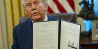 US President Donald Trump signs executive orders in the Oval Office of the White House in Washington, DC on 30 January 2025. (Photo: EPA-EFE / Bonnie Cash)
