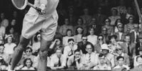Eric Sturgess (1920-2004) of South Africa reaches to make a forehand return against Bernard Destremau of France during their Men's Singles Fourth Round match on Centre Court at the Wimbledon Lawn Tennis Championship on 29th June 1951 at the All England Lawn Tennis and Croquet Club in Wimbledon in London, England. Eric Sturgess won the match 6 - 2, 6 - 3, 6 - 2. ( Photo by Reg Burkett/Keystone/Hulton Archive/Getty Images )