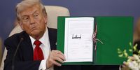 US President Donald Trump shows a signed document at the Gaza Peace Summit in Sharm El-Sheikh, Egypt, on 13 October 2025. (Photo: EPA / Yoan Valat / Pool)