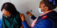 25 year old Siphesihle Hlatshwayo gets her jab from Nurse Nomsa Nkosi at the Power FM offices in Houghton Johannesburg. She said she felt relieved and said it was about time that her age group was able to get vaccinated.<br>Photo / Shiraaz Mohamed.