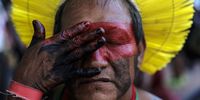 An indigenous person paints himself for the typical dances of his people during the Amazon Dialogues, prior to the leaders' summit to be held a week later, in the city of Belem, Para state, northern Brazil, 04 August 2023.  EPA-EFE/Antonio Lacerda