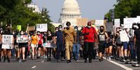 WASHINGTON, DC - JUNE 03: Demonstrators march down Pennsylvania Avenue near the Trump International Hotel during a protest against police brutality and the death of George Floyd, on June 3, 2020 in Washington, DC. Protests in cities throughout the country have been been held after the death of George Floyd, a black man who was killed in police custody in Minneapolis on May 25.  (Photo by Tasos Katopodis/Getty Images)