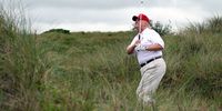 ABERDEEN, SCOTLAND - JULY 10:  Donald Trump plays a round of golf after the opening of The Trump International Golf Links Course on July 10, 2012 in Balmedie, Scotland. The controversial £100m course opens to the public on Sunday July 15. Further plans to build hotels and homes on the site have been put on hold until a decision has been made on the building of an offshore windfarm nearby. (Photo by Ian MacNicol/Getty Images)