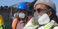 Members of Parliament Narend Singh (left) and  Simphiwe Mbatha wear gas masks while inspecting the remnants of the UPL warehouse. (Photo: Tony Carne)