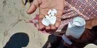 A resident displays a handful of the prescription pills that have washed up on the Wild Coast. (Photo: Supplied)