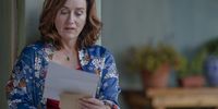 Maria reading a letter in 'Recipes for Love and Murder'. Image: Patrick Toselli/AcornTV