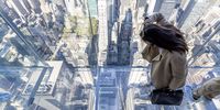 epa09500163 A person looks down at city streets while standing in the ?Levitation? space, which features a glass floor and is one of the rooms in the new Summit One Vanderbilt observation deck, being called ?Air by Kenzo Digital?, in New York, New York, USA, 01 October 2021. The observation floors, which have 360 views of New York City from the top of the One Vanderbilt building, are designed as immersive art experiences designed by artist Kenzo Digital, and will open to the public on 21 October 2021.  EPA-EFE/JUSTIN LANE