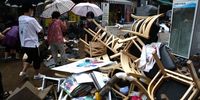 SEOUL, SOUTH KOREA - AUGUST 09: People clean up debris at a traditional market damaged by flood after torrential rain on August 09, 2022 in Seoul, South Korea. The heaviest rainfall in 80 years has pounded Seoul and surrounding regions, leaving seven people dead and six others missing, as well as flooding homes, vehicles, buildings and subway stations, government officials said. (Photo by Chung Sung-Jun/Getty Images)