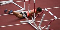 TOKYO, JAPAN - AUGUST 04:  Taio Kanai of Team Japan trips in the Men's 110m Hurdles Semi-Final on day twelve of the Tokyo 2020 Olympic Games at Olympic Stadium on August 04, 2021 in Tokyo, Japan. (Photo by Matthias Hangst/Getty Images)
