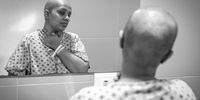 Nasreen examines herself in a hospital bathroom mirror. (Photo: Shiraaz Mohamed)