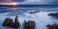 The rugged, rocky coastline at De Kildare  with views of the sunset over Walker Bay on the Whale Coast in the Western Cape. Photographer: Roger de la Harpe<br>