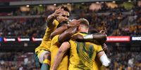 Will Genia of the Wallabies (left) celebrates a try with teammates during the Rugby Championship match between Australia and Argentina at Suncorp Stadium in Brisbane, Australia, July 27, 2019.  (Photo: EPA-EFE/DAN PELED)