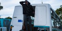 Bruce Mkhwanazi, the bus driver (left) and Skhaftin team member Abdulaye Matsoso (right) outside Masifunde Learner Development, Gqeberha, Eastern Cape. (Photo: Julia Evans)