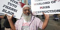 A member of the Muslim political party Al Jama-ah holds placards in a protest against former British Prime Minister Tony Blair’s address at the Discovery Leadership Summit, in Johannesburg, South Africa, 30 August 2012. (Photo: EPA / Kim Ludbrook)