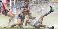 SYDNEY, AUSTRALIA - MARCH 20: Nick Cotric and Corey Allan of the Bulldogs dive for the ball in the wet during the round two NRL match between the Canterbury Bulldogs and the Penrith Panthers at Bankwest Stadium, on March 20, 2021, in Sydney, Australia. (Photo by Mark Kolbe/Getty Images)