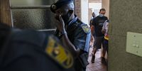 Stefanus Johannes Fourie (back of image, wearing a blue mask) is led into the courtroom by police. (Photo: Shiraaz Mohamed)