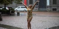 A woman reacts during rain fall in Milan, Italy, 28 August 2023. Many regions in northern Italy were affected by torrential rainfall, highly charged thunder storms, strong winds and landslides.  EPA-EFE/DAVIDE CANELLA