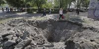 A person stands next to a shell crater near a residential building after a missile strike in Kyiv (Kiev), Ukraine, 01 June 2023, amid the Russian invasion. At least three people died, including a child, and ten others were injured after a missile attack on the Ukrainian capital, the National Police said. Russian troops entered Ukrainian territory in February 2022, starting a conflict that has provoked destruction and a humanitarian crisis.  EPA-EFE/SERGEY DOLZHENKO