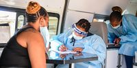Health workers test for COVID-19 at a mobile testing centre at Springfield Informal Centre in Umgeni on April 29, 2020 in Durban, South Africa. According to media reports, the KZN provincial government together with the National Department of Health launched a community screening and testing programme to help in the fight against COVID-19.