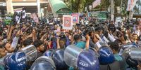 Bangladeshi police members stop the Bangladesh Nationalist Party’s family members as they gather to demand the immediate release of all leaders and activists and to  submit a memorandum to the chief justice, in front of the National Press Club in Dhaka, Bangladesh, on 28 November 2023. (Photo: EPA-EFE / Monirul Alam)